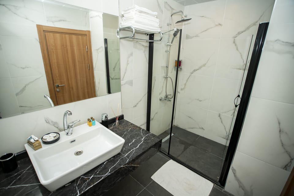Shower, hair dryer, slippers, towels