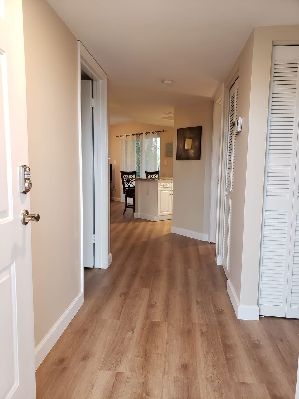 Entrance hallway into the condo - brand new floors throughout condo