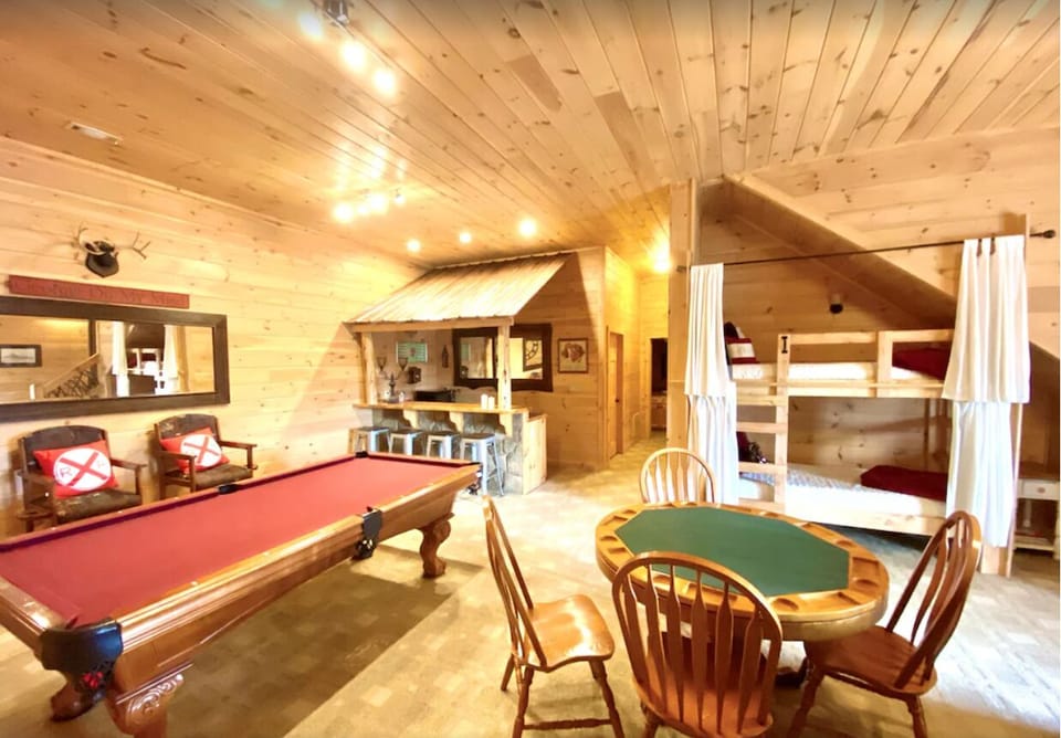 Huge rec room with pool table, bar, game table, recliner sofa, TV, firieplace