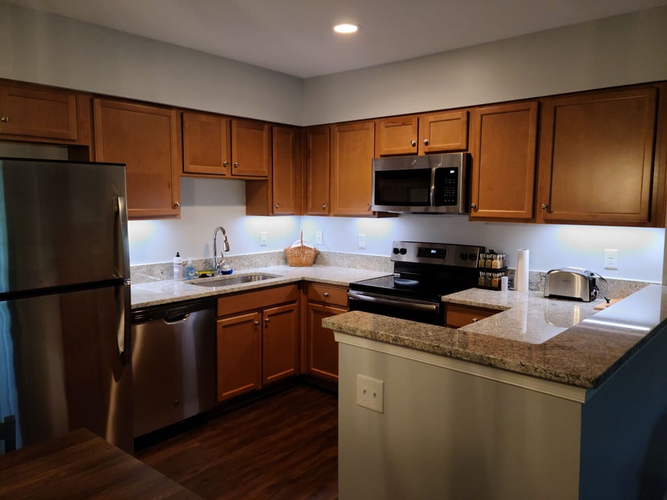 Modern kitchen with granite and stainless steel appliances.