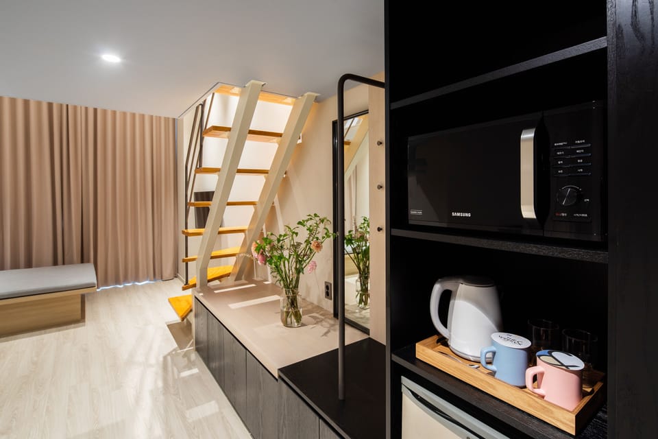 Urban Duplex (No Kitchenette) | Living area | Flat-screen TV, heated floors