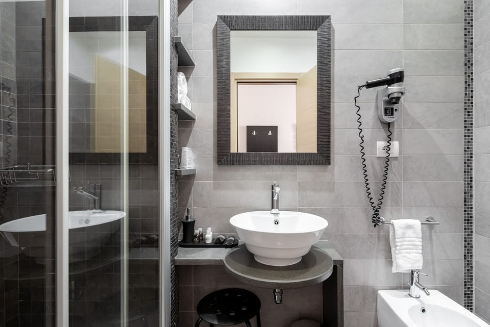 Shower, rainfall showerhead, designer toiletries, hair dryer