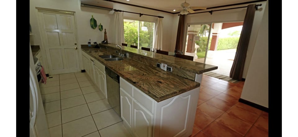 Kitchen and breakfast room with large sliding doors to the patio. 