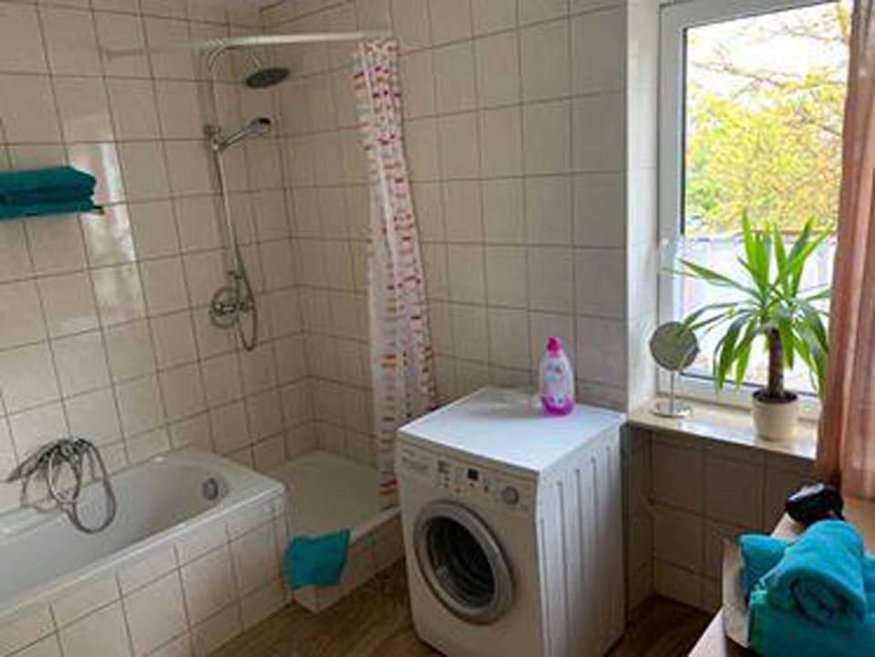 Apartment | Bathroom | Separate tub and shower, hair dryer, towels, toilet paper