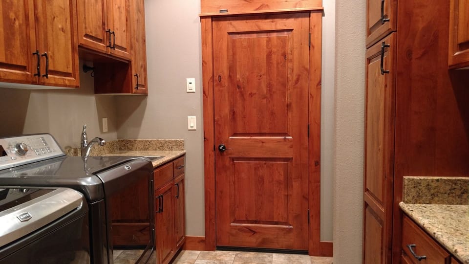 Laundry room with full sized washer and dryer. Detergent and dryer sheets.