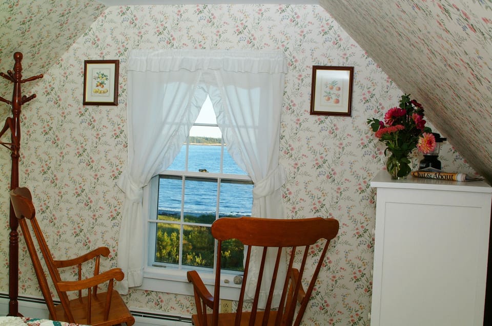 Bedroom 7 with queen sized bed, ocean view, en-suite bathroom w/ claw foot tub.