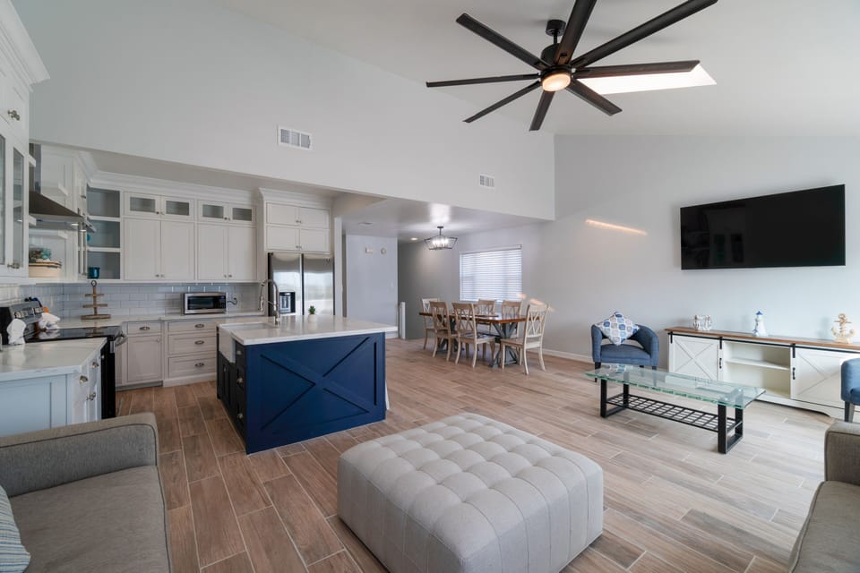 Spacious open concept living room on 2nd floor, with large flat screen TV.