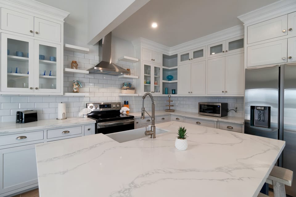 Modern kitchen with large center island and bar seating.