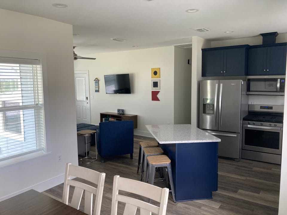 View from dining to kitchen to living room area. Great light and very open.