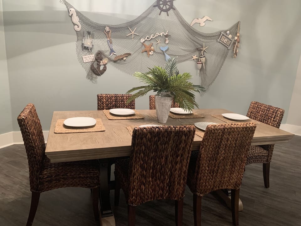Large table in the dining area with 6 dining chairs.  