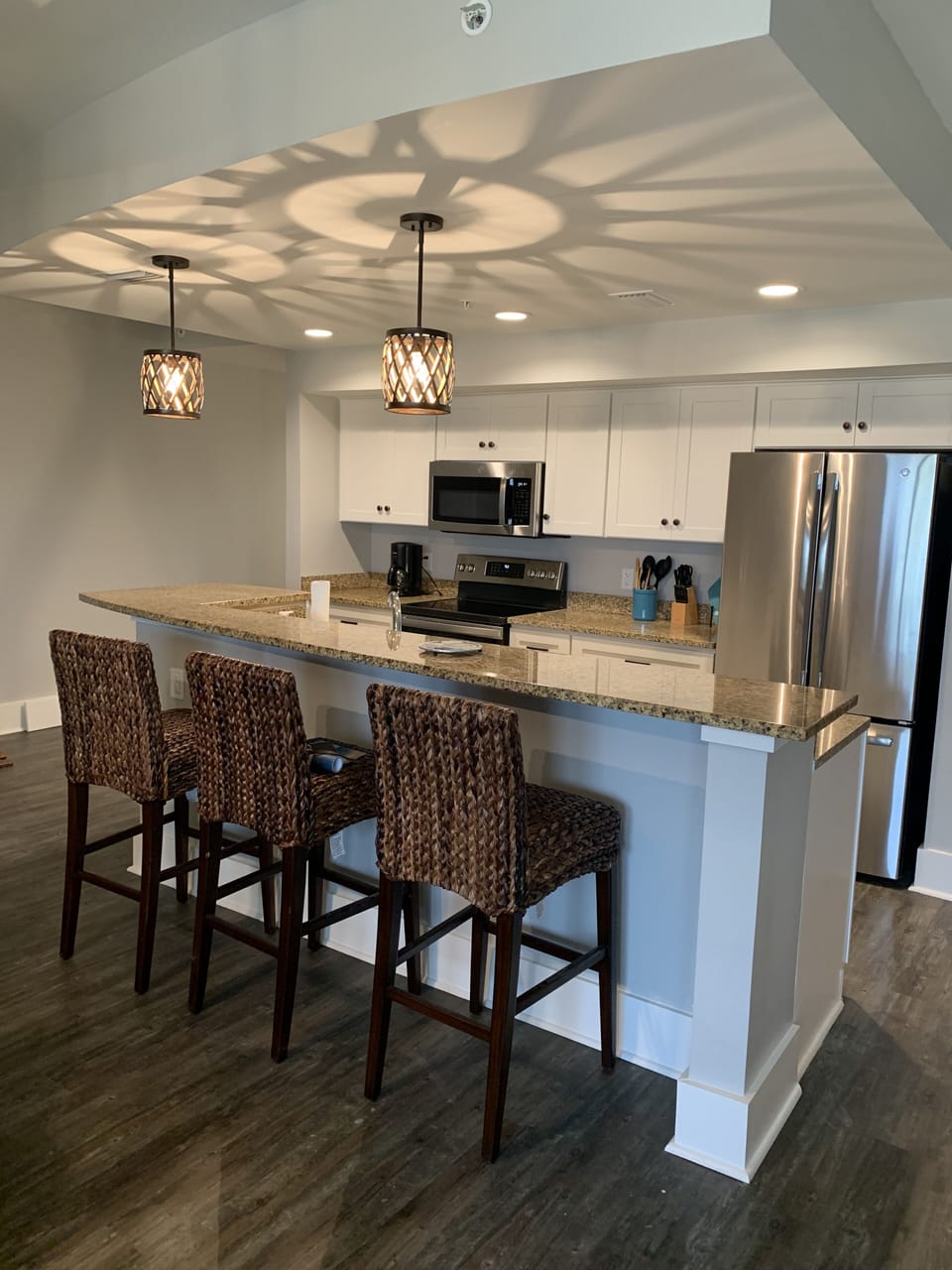 Beautiful white kitchen with granite tops and new stainless appliances.