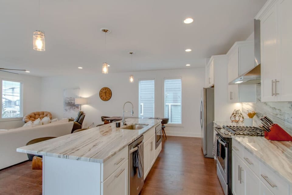 Kitchen with white cabinets and marble countertop island