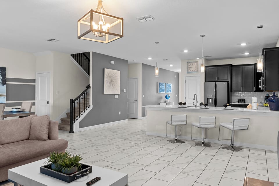 Your modern open-concept space blends kitchen and living seamlessly with sleek countertops, contemporary fixtures, and warm lighting.