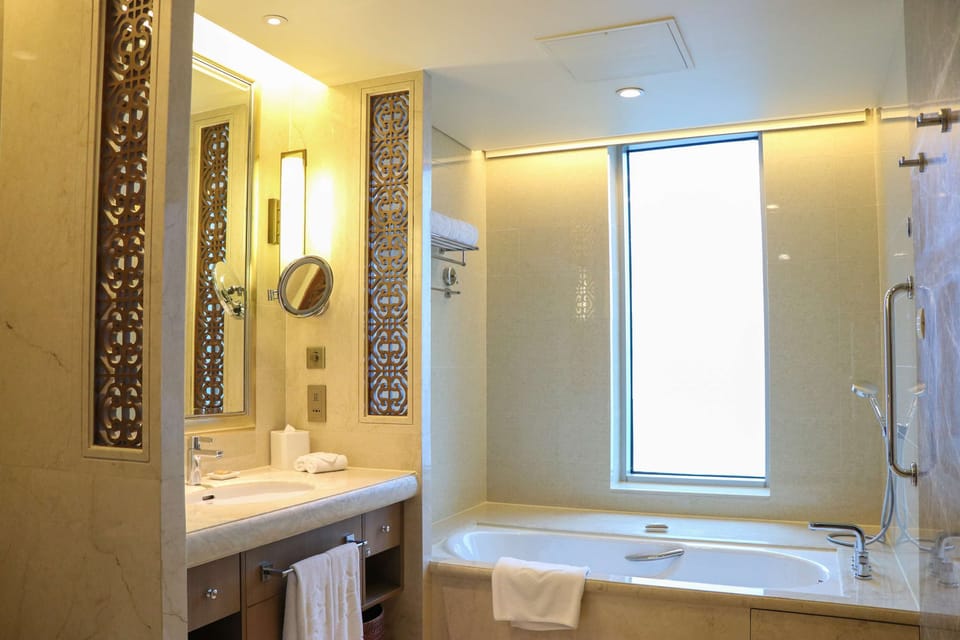 Separate tub and shower, designer toiletries, hair dryer, slippers