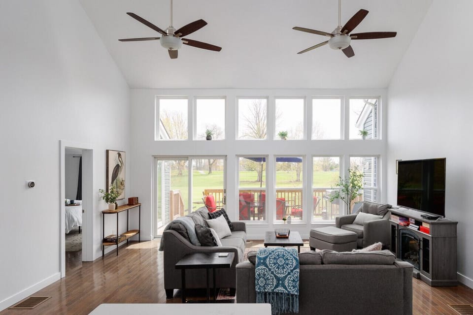 Open Concept Living Room w/ Cathemeral Ceilings & Wall High Windows