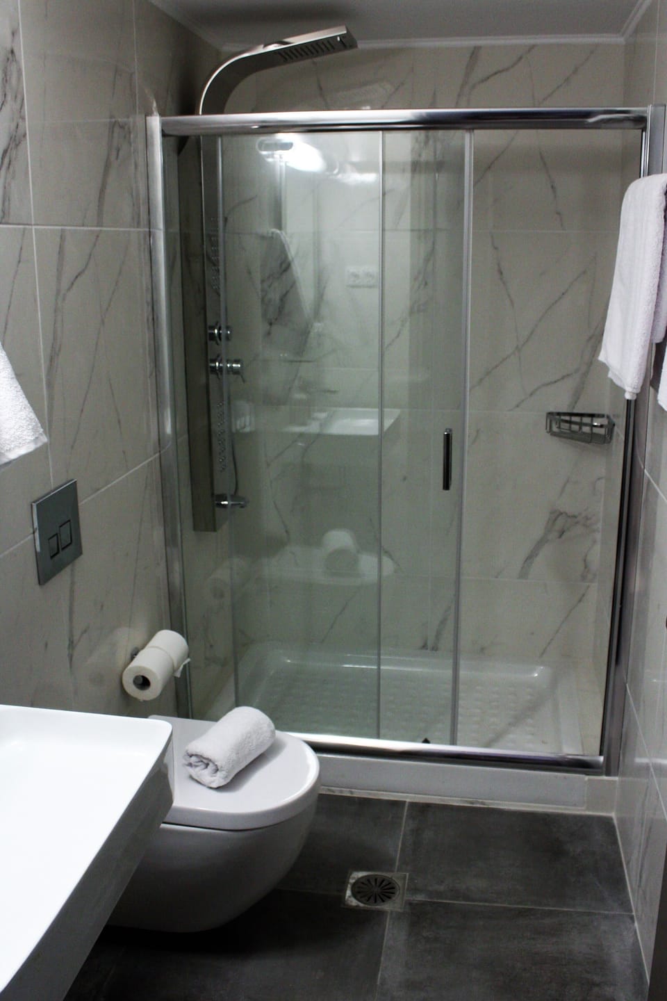 Shower, hair dryer, slippers, towels