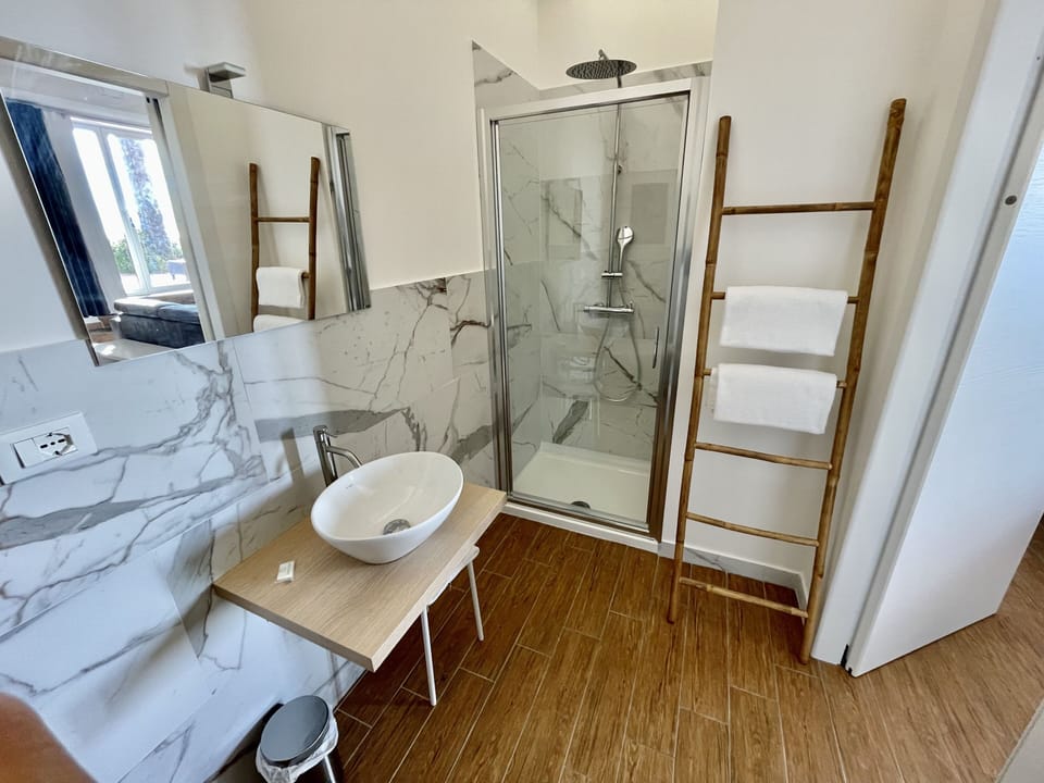 Panoramic Studio Suite, Jetted Tub, Sea View | Bathroom | Shower, hydromassage showerhead, free toiletries, hair dryer