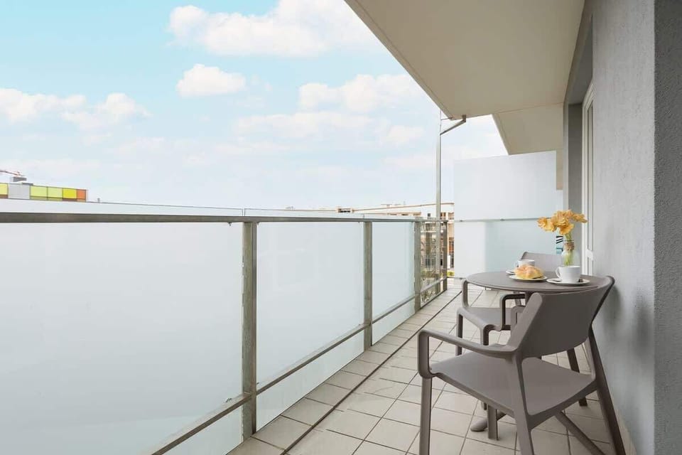 Atmospheric balcony of with chairs and table, where the guests can relax.
