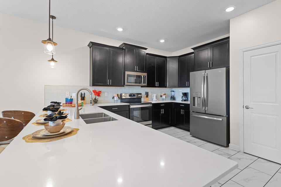 You'll love cooking in this sleek, modern kitchen with premium appliances and gleaming quartz countertops.