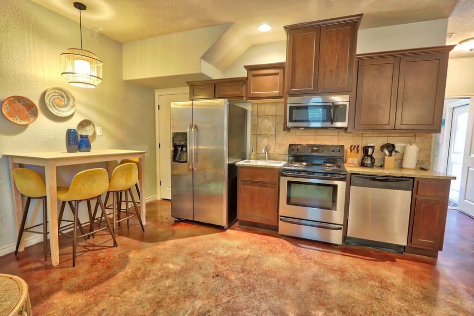Full kitchen with a stove, oven, refrigerator, and microwave in the downstairs suite.