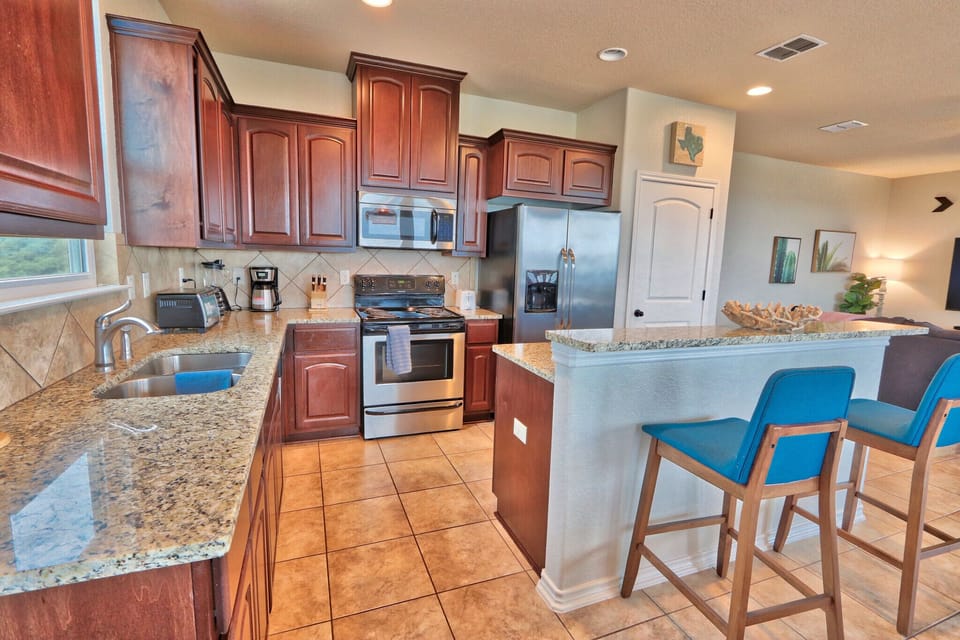 Full kitchen with refrigerator, oven, stove, and coffee pot