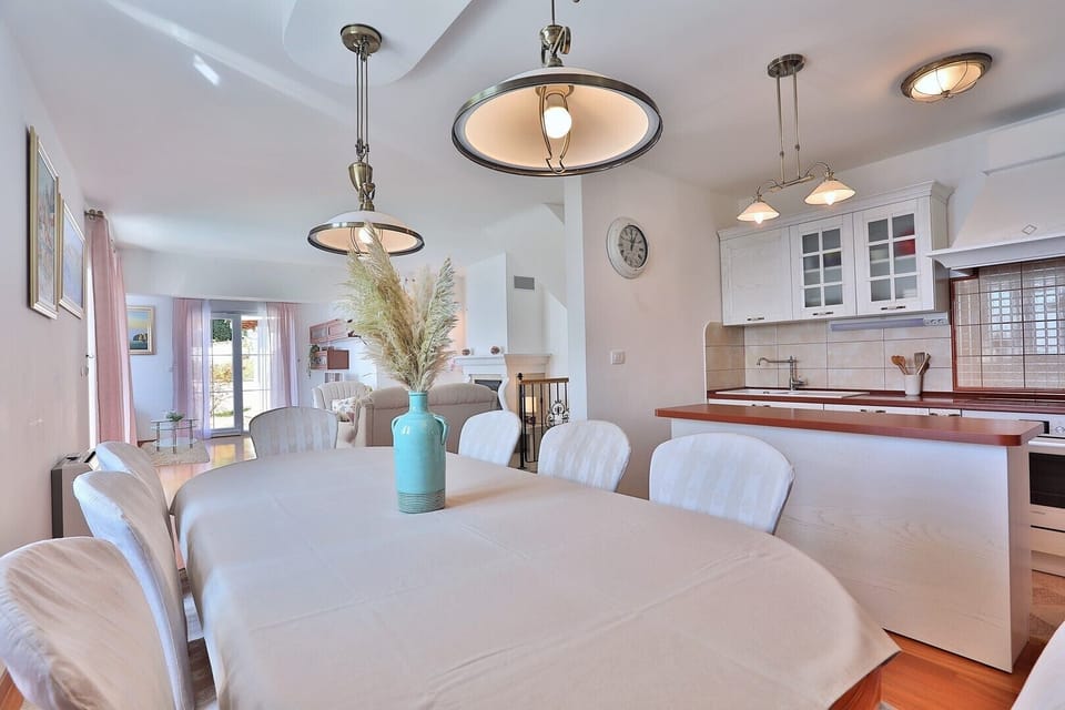 Spacious living area on the ground floor with TV, AC, and exit to the terrace.