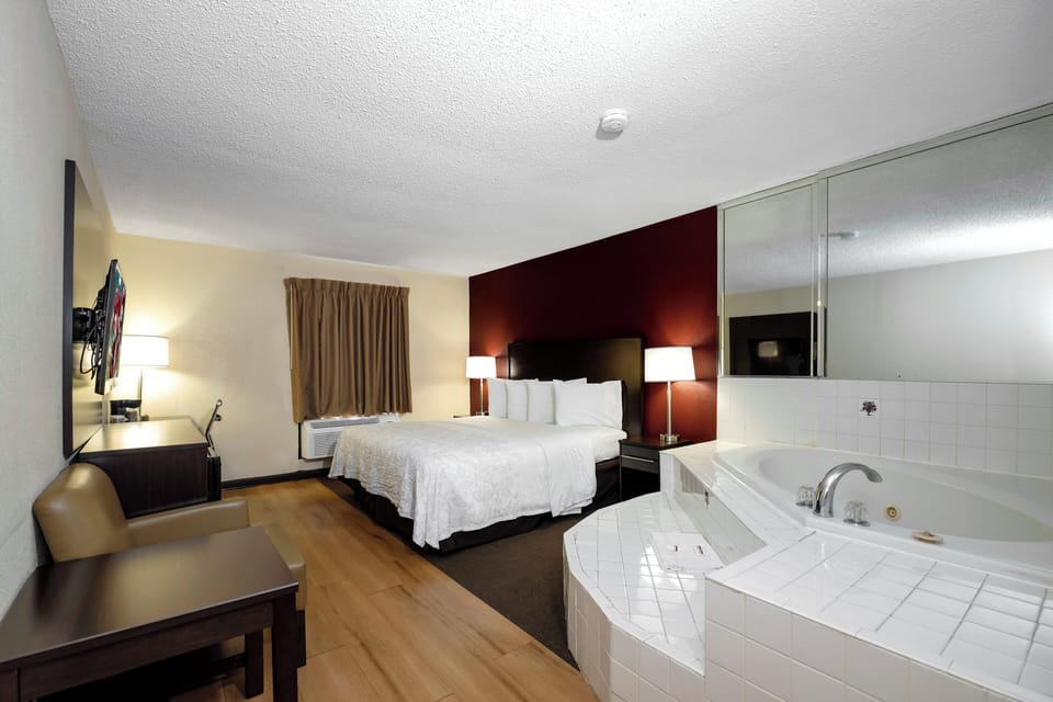 Premium bedding, desk, laptop workspace, blackout drapes
