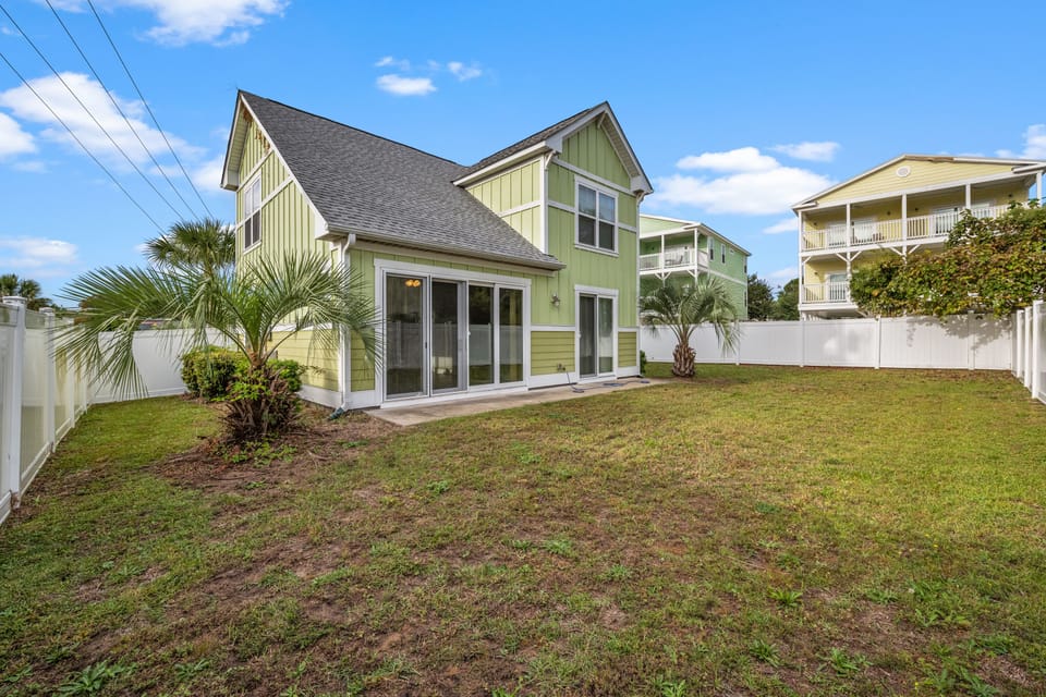 Relax with family in the living room while the kids play in the fenced back yard