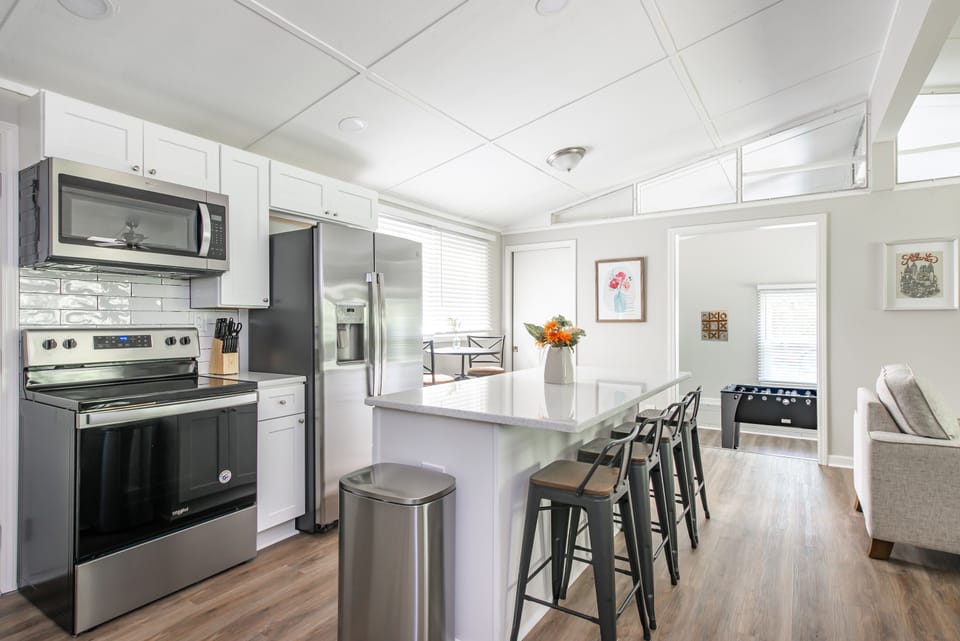 Open kitchen with quartz counters and stainless steel appliances