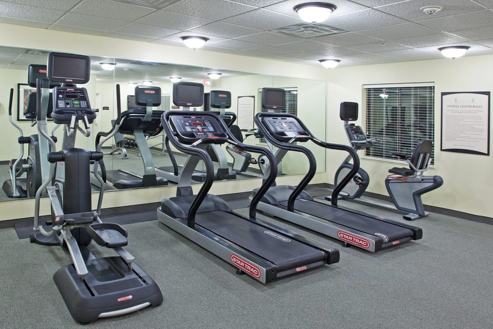 Fitness center with treadmills, elliptical machines, and cardio equipment — open 24 hours