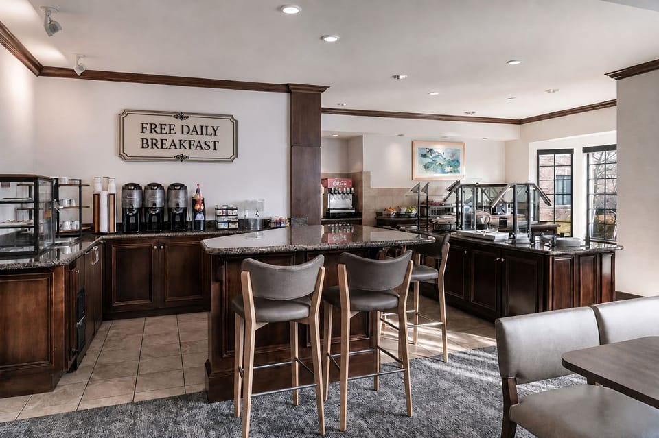 Breakfast buffet with hot dishes, fresh fruit, and coffee — complimentary for all guests Mon–Fri