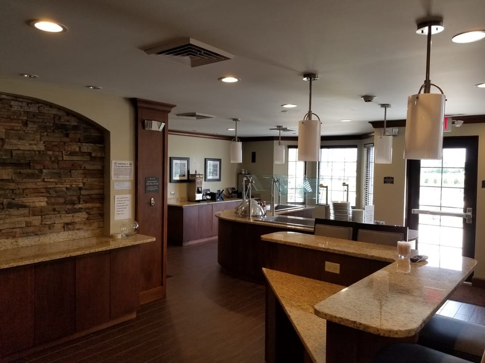 Dining area with stone accent wall and table seating.