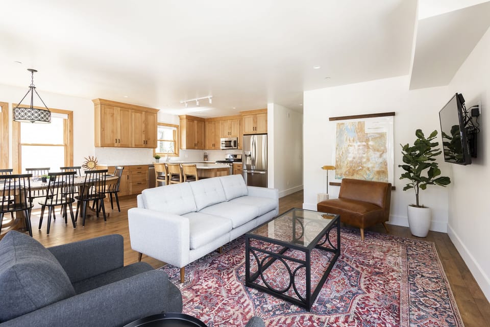 Living room with couch, coffee table, flat screen TV, and additional comfortable seating