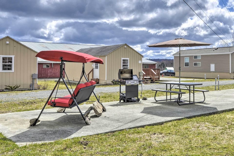 The patio features a gas grill and bench swing.