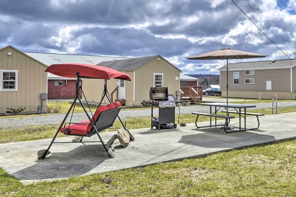 The patio features a gas grill and bench swing.