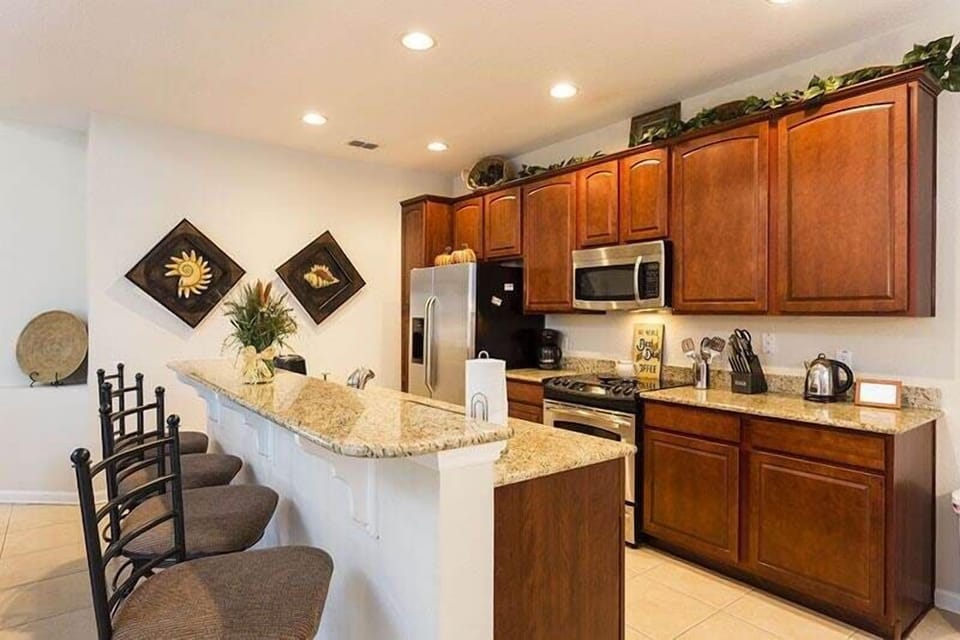 View 2 of beautiful kitchen area with microwave, oven, dishwasher, and double door refrigerator
