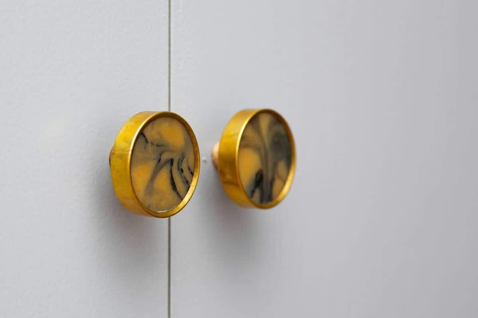 A close-up of brass knobs adding an elegant, artistic detail to the interior.
