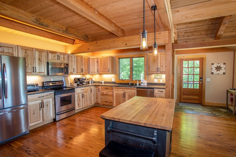 Open Kitchen with Butcher Block Island offering 2 Bar Stool Seats