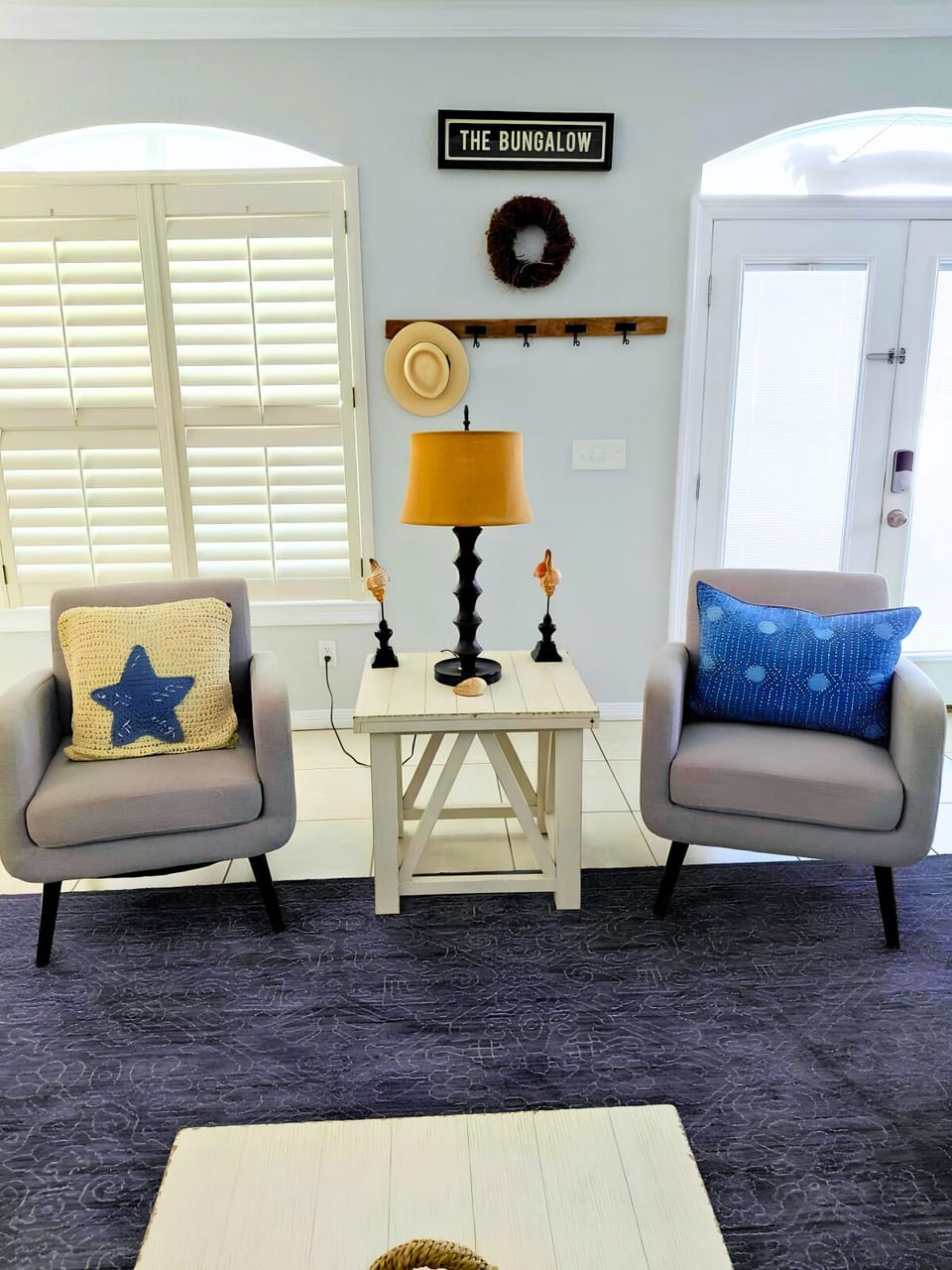 Open Living Area: Cozy seating with a smart TV and coastal decor.
