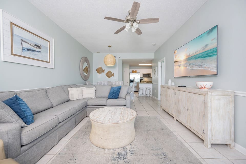 Relax in the spacious living area, featuring comfortable seating, sofa with queen sleeper, and a large TV