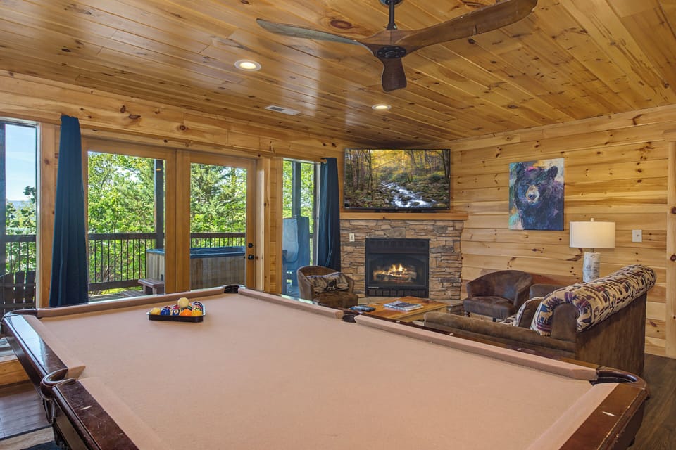 Gather around your private pool table for friendly competitions while the fireplace crackles nearby, creating perfect mountain retreat vibes.