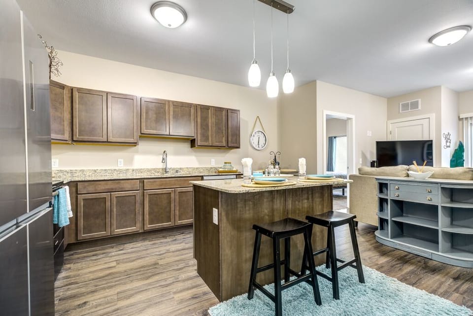 Full kitchen with stainless steel appliances and dishwasher.