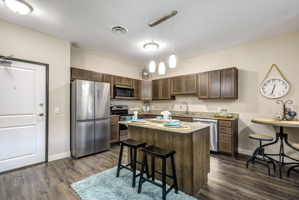 Full kitchen with stainless steel appliances and dishwasher.  Breakfast bar.