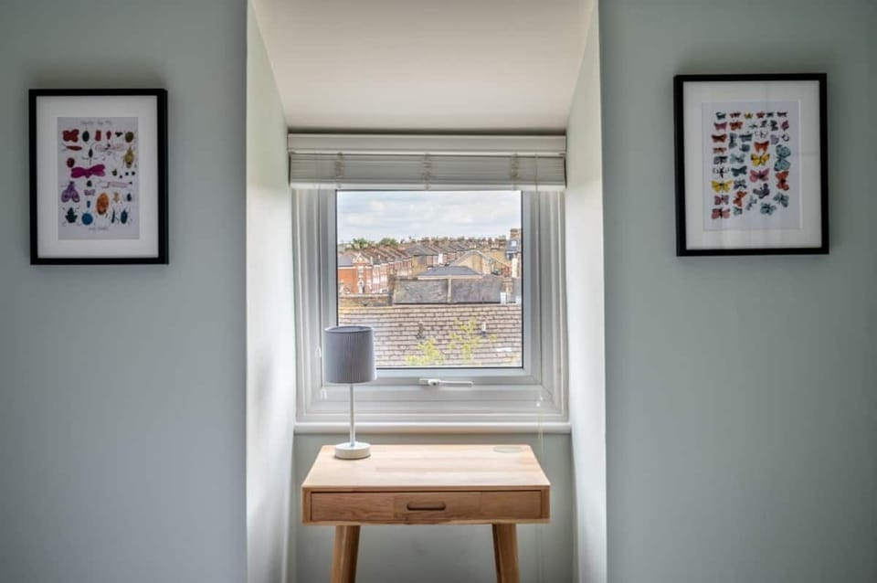 Bedroom with dressing table/laptop desk with London rooftop views