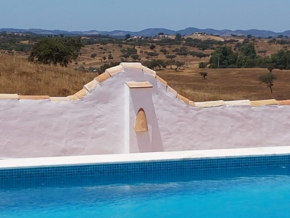 Hills in the distance, over the poolside wall.