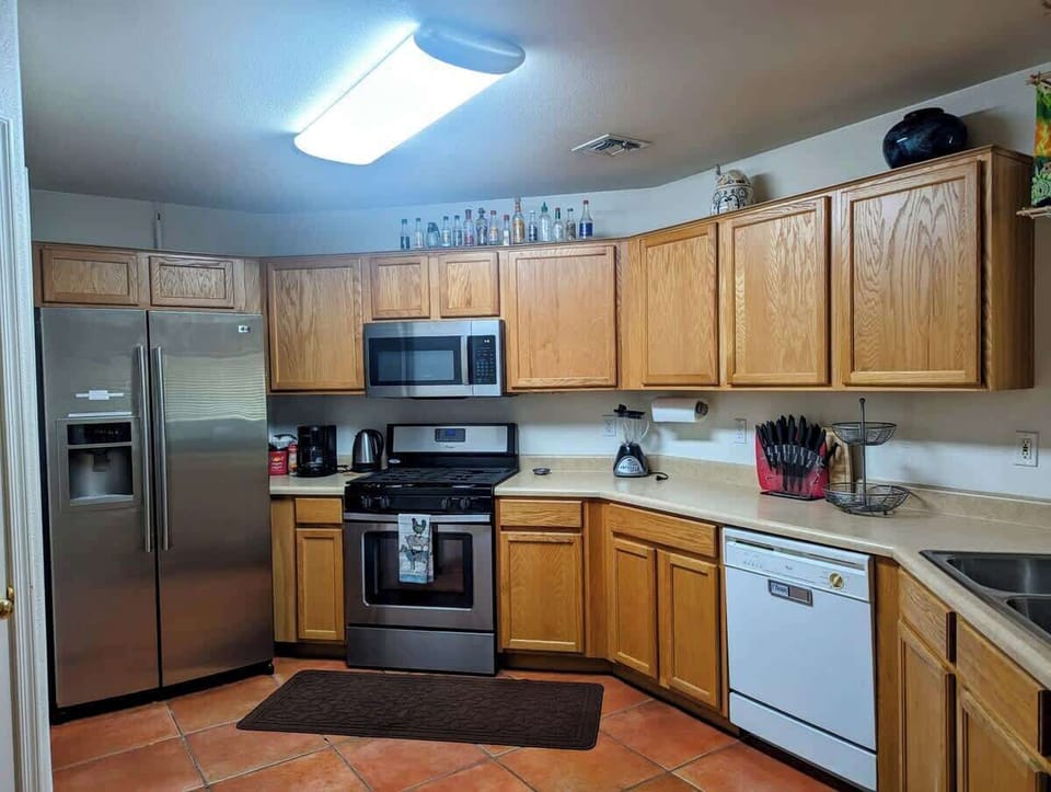 Fully Stocked Kitchen with coffee station, refrigerator, stove, oven, microwave, dishwasher, dinnerware, kids' dinnerware, cookware, rice cooker, and various cooking oils and spices for prepping meals as desired.