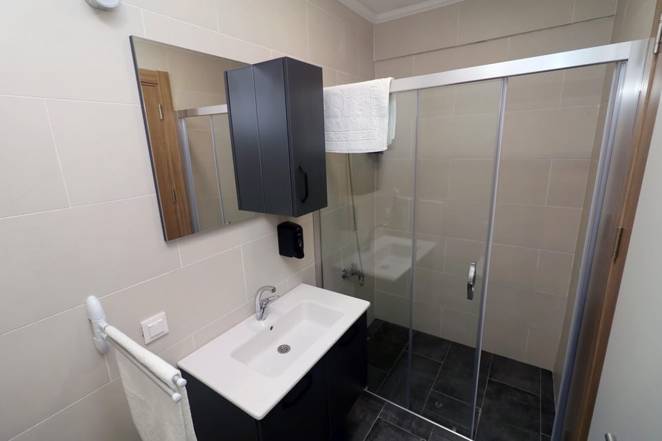 Village Room | Bathroom | Shower, slippers, towels, soap