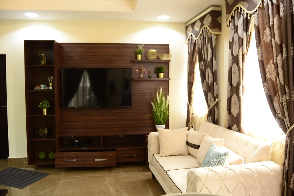 Deluxe Apartment | Living area | 100-inch plasma TV with cable channels, TV