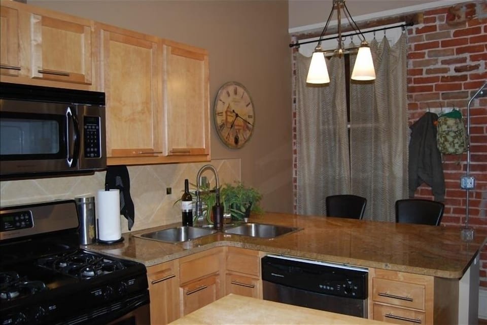 granite counters, exposed brick in kitchen