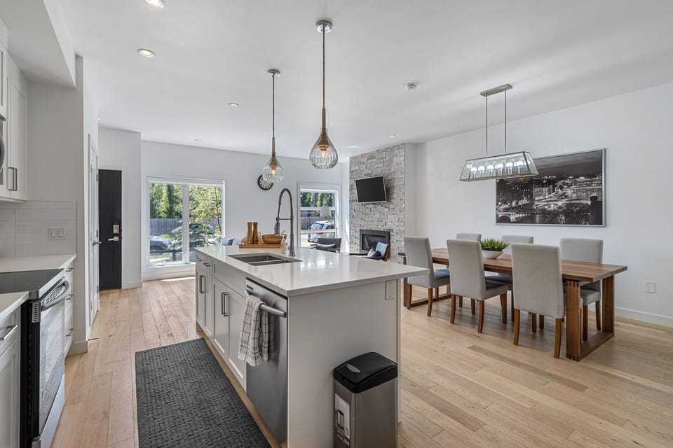 Beautiful, neat and well-lit kitchen and dining area.